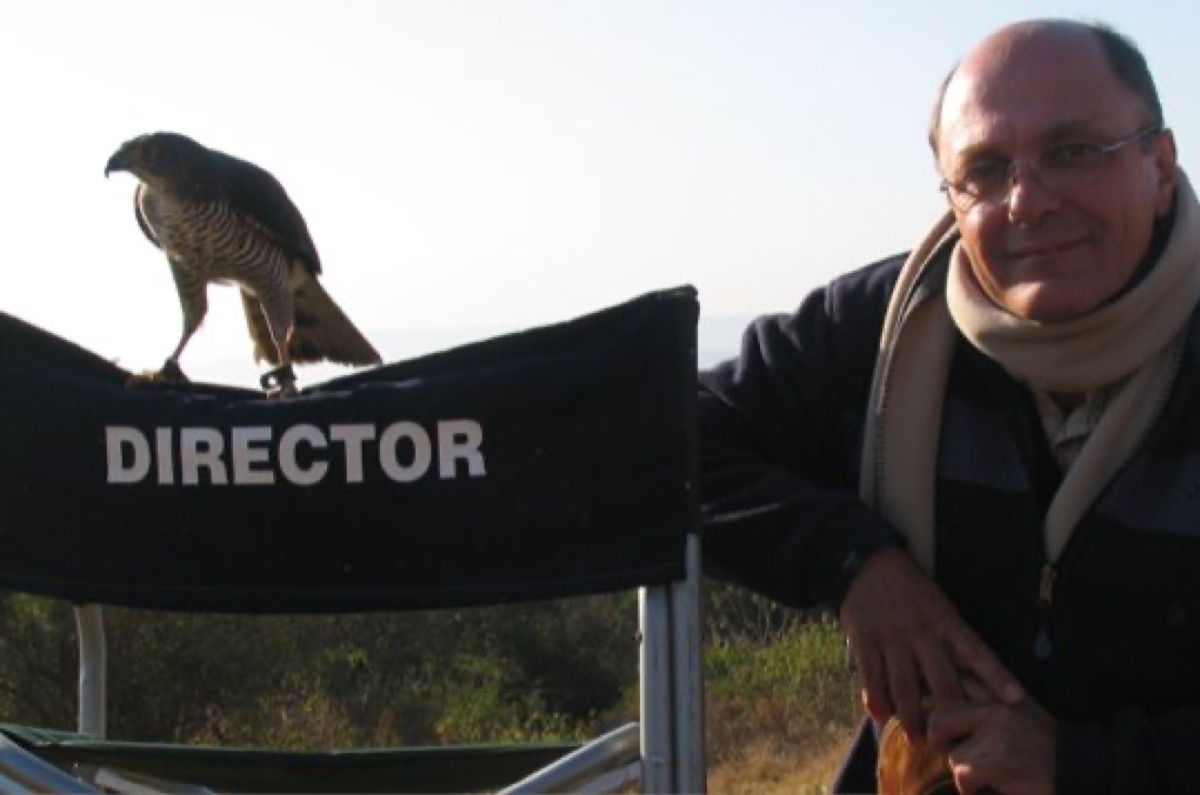 Director's chair on set with film reels and cameras